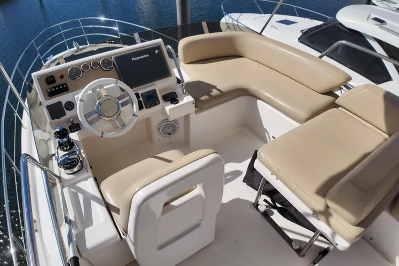  Yacht Photos Pics Flybridge of 2012 Azimut 40 FLY yacht with beige seating and modern controls.