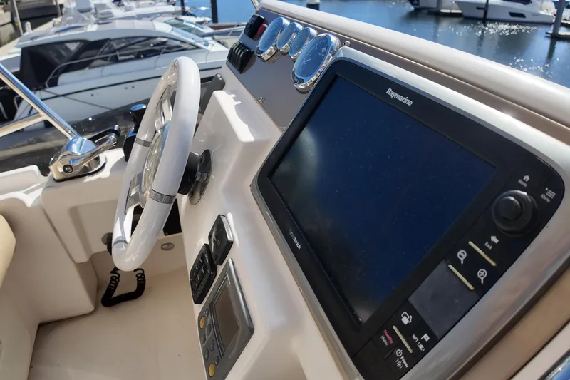  Yacht Photos Pics Cockpit of 2012 Azimut 40 FLY yacht with steering wheel and navigation system.