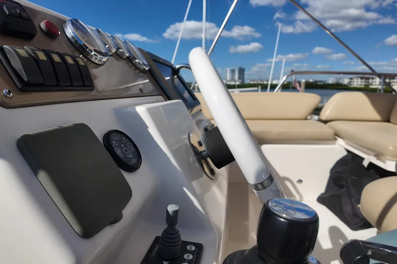  Yacht Photos Pics Helm of 2012 Azimut 40 FLY yacht with steering wheel and controls, under clear blue sky.