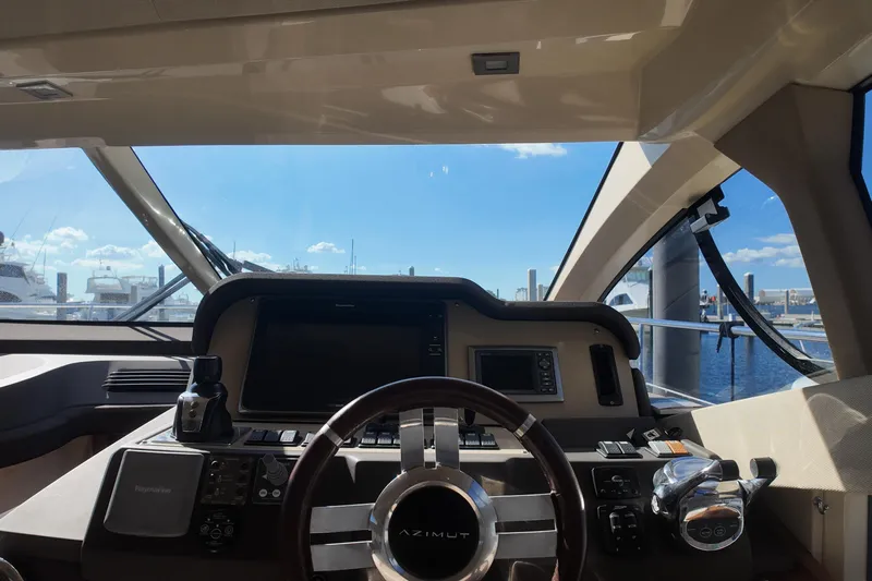  Yacht Photos Pics Cockpit view of 2012 Azimut 40 FLY yacht with steering wheel and navigation controls.