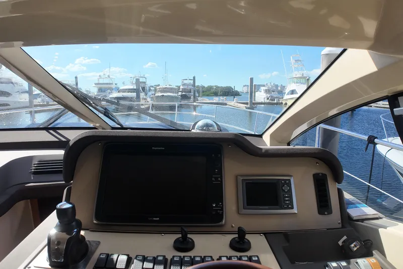  Yacht Photos Pics Cockpit view of 2012 Azimut 40 FLY yacht at marina, clear skies.