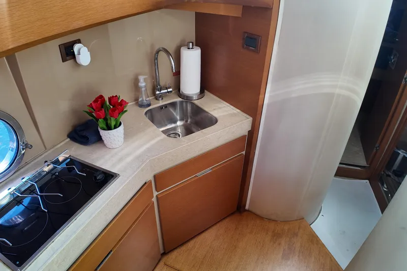  Yacht Photos Pics Compact kitchen area in 2012 Azimut 40 FLY yacht with sink and stove.