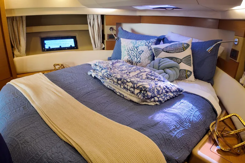  Yacht Photos Pics Luxurious bedroom interior of 2012 Azimut 40 FLY yacht with nautical-themed decor.