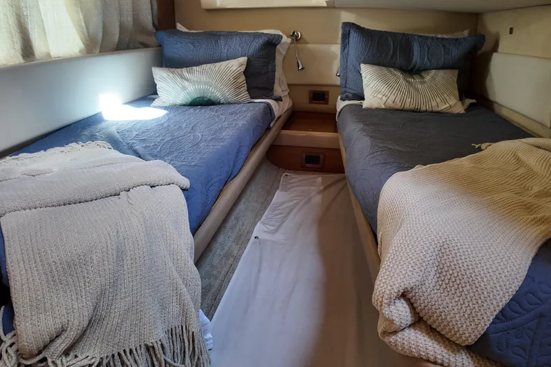  Yacht Photos Pics Twin beds in a cozy cabin of a 2012 Azimut 40 FLY yacht.