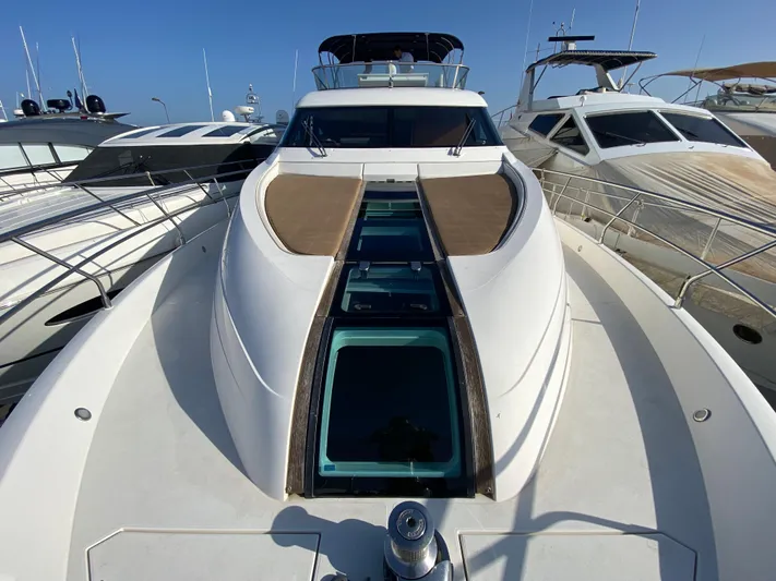 Coco Yacht Photos Pics 2012 Fairline Squadron 65 yacht with sleek design, docked alongside other luxury boats.