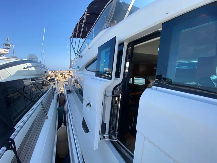 Coco Yacht Photos Pics 2012 Fairline Squadron 65 yacht docked, showcasing sleek design and modern features.