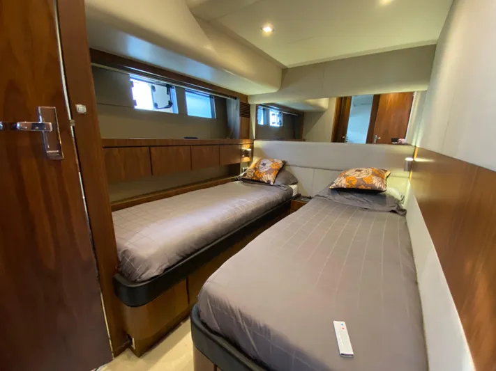 Coco Yacht Photos Pics Twin cabin interior of 2012 Fairline Squadron 65 yacht, featuring modern design and cozy bedding.