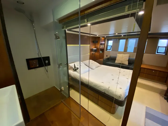 Coco Yacht Photos Pics Luxurious bedroom interior of 2012 Fairline Squadron 65 yacht with modern design and glass shower.