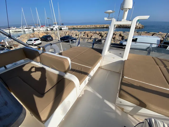 Coco Yacht Photos Pics Flybridge of 2012 Fairline Squadron 65 yacht with beige seating, docked at marina.