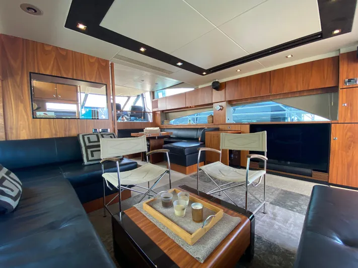 Coco Yacht Photos Pics Luxurious interior of 2012 Fairline Squadron 65 yacht with modern seating and wooden accents.