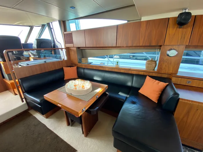 Coco Yacht Photos Pics Luxurious interior of 2012 Fairline Squadron 65 yacht with elegant seating and wooden finishes.