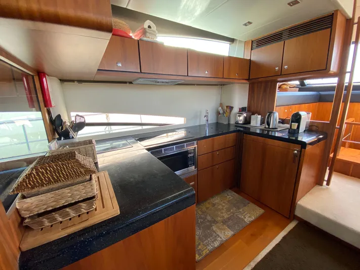 Coco Yacht Photos Pics Luxurious 2012 Fairline Squadron 65 yacht kitchen with modern appliances and wooden cabinetry.