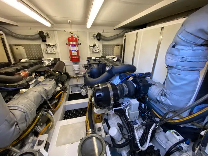 Coco Yacht Photos Pics Engine room of 2012 Fairline Squadron 65 yacht, featuring complex machinery and fire safety equipment.