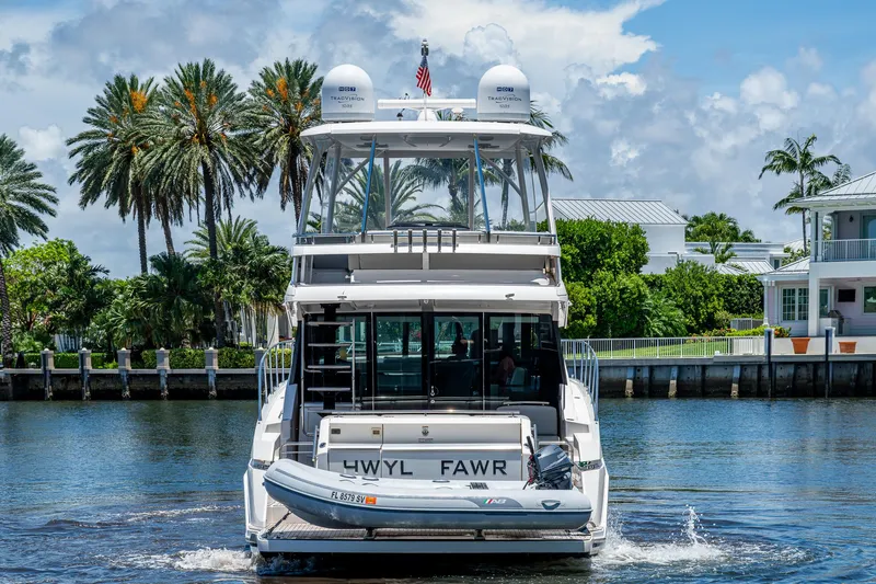 Hwyl Fawr Yacht Photos Pics 2018 Tiara Yachts F53 Flybridge cruising on a sunny day near waterfront homes.