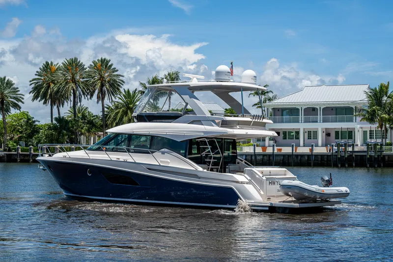 Hwyl Fawr Yacht Photos Pics 2018 Tiara Yachts F53 Flybridge cruising on a sunny day near waterfront homes.