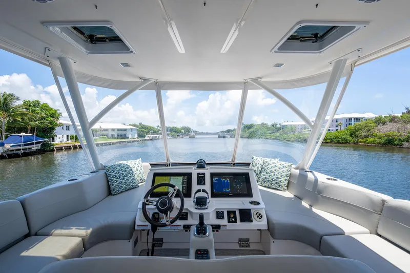 Hwyl Fawr Yacht Photos Pics 2018 Tiara Yachts F53 Flybridge interior with modern helm, overlooking serene waterway.