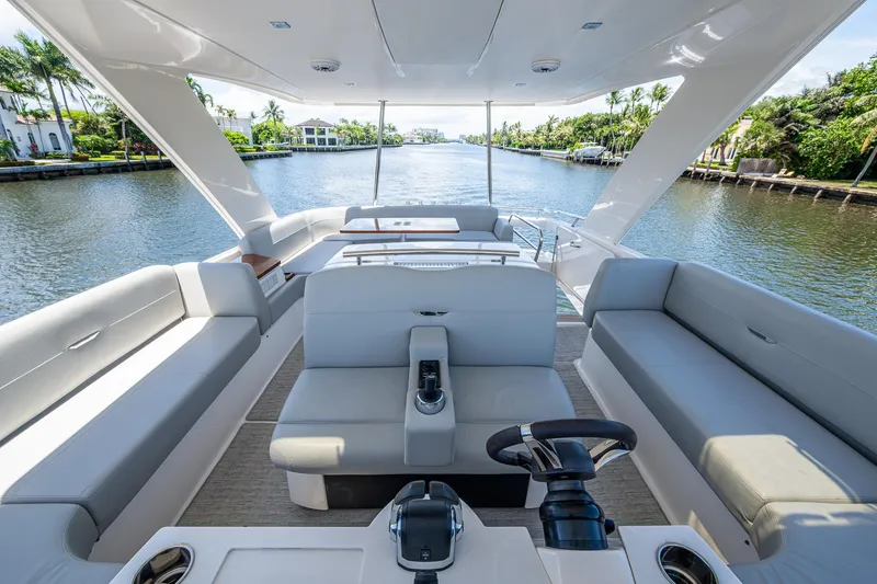 Hwyl Fawr Yacht Photos Pics 2018 Tiara Yachts F53 Flybridge interior with luxurious seating and scenic waterway view.