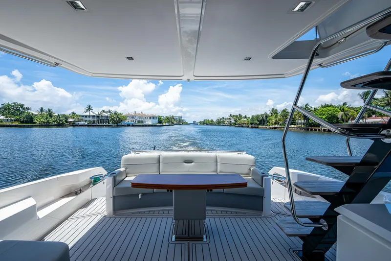 Hwyl Fawr Yacht Photos Pics 2018 Tiara Yachts F53 Flybridge, elegant deck view, serene waterfront backdrop.