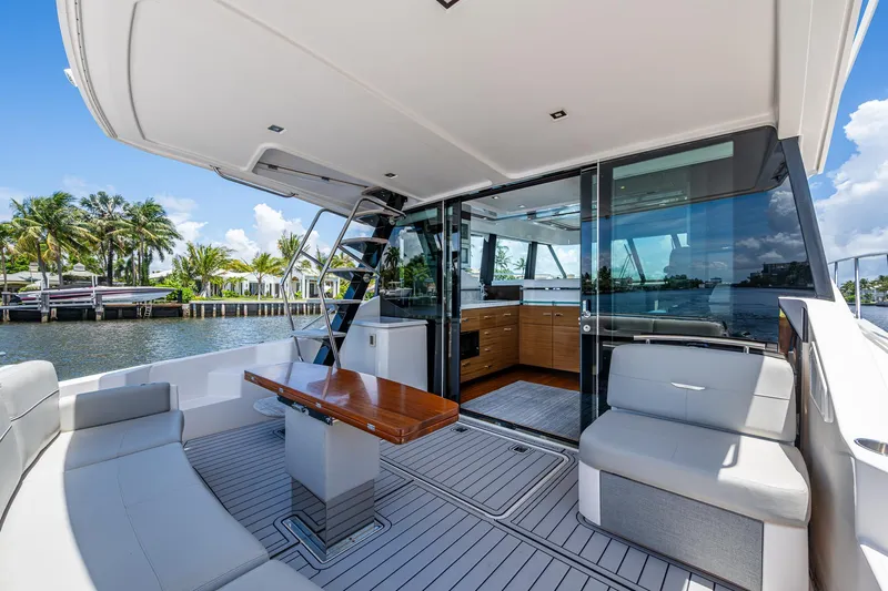 Hwyl Fawr Yacht Photos Pics 2018 Tiara Yachts F53 Flybridge with elegant seating and waterfront view.