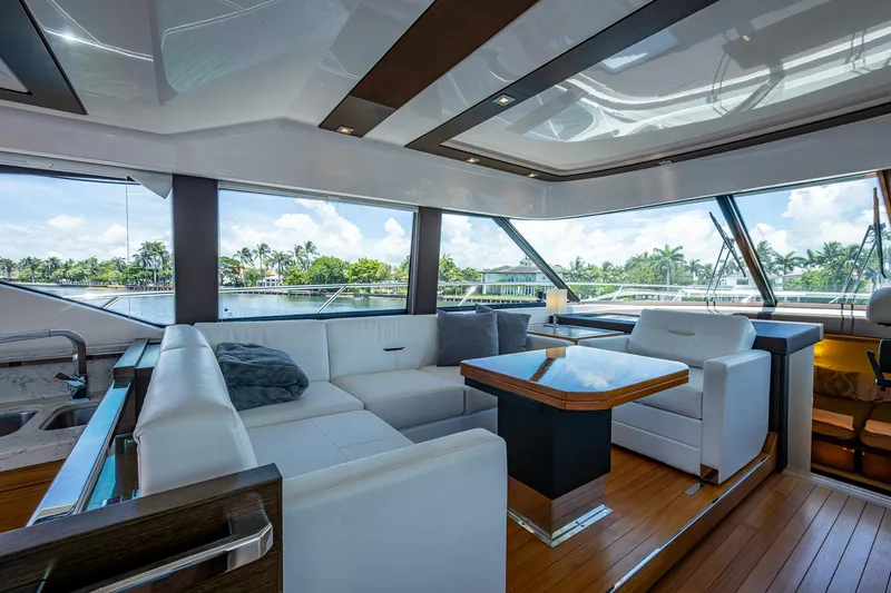 Hwyl Fawr Yacht Photos Pics Luxurious interior of 2018 Tiara Yachts F53 Flybridge with elegant seating and panoramic windows.