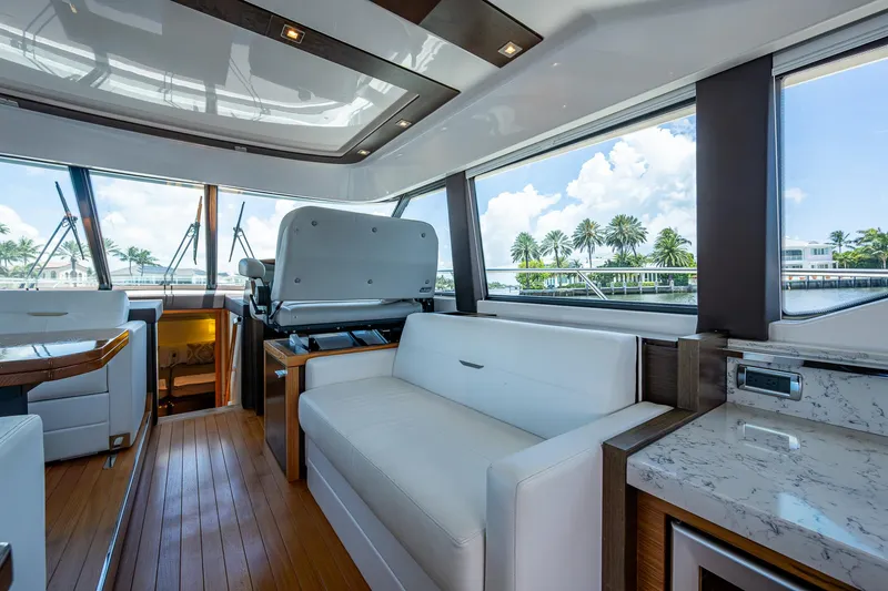 Hwyl Fawr Yacht Photos Pics Luxurious interior of 2018 Tiara Yachts F53 Flybridge with modern seating and panoramic windows.