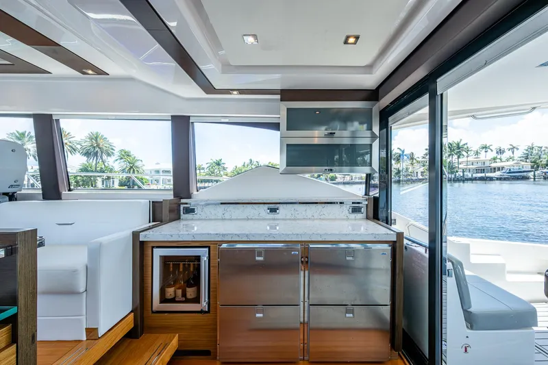 Hwyl Fawr Yacht Photos Pics Luxurious interior of 2018 Tiara Yachts F53 Flybridge with modern kitchen and scenic water view.