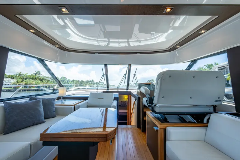 Hwyl Fawr Yacht Photos Pics Luxurious interior of 2018 Tiara Yachts F53 Flybridge with panoramic windows and elegant seating.