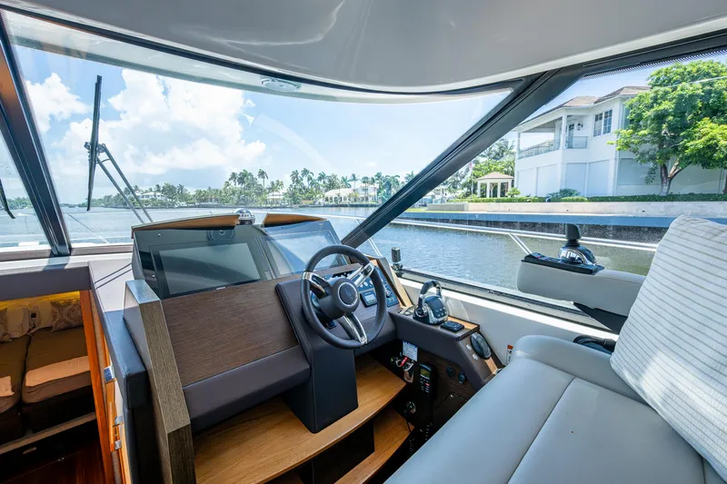 Hwyl Fawr Yacht Photos Pics 2018 Tiara Yachts F53 Flybridge helm with waterfront view and luxurious interior.