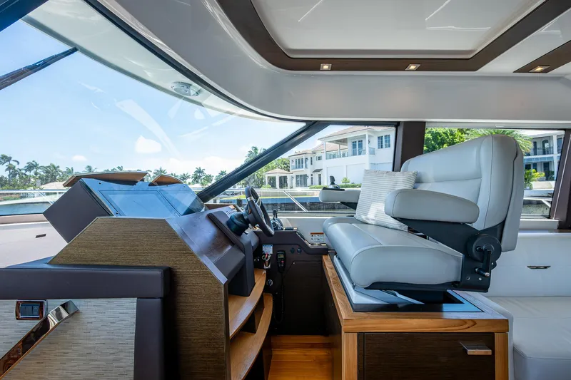 Hwyl Fawr Yacht Photos Pics 2018 Tiara Yachts F53 Flybridge helm with luxurious seating and modern controls.