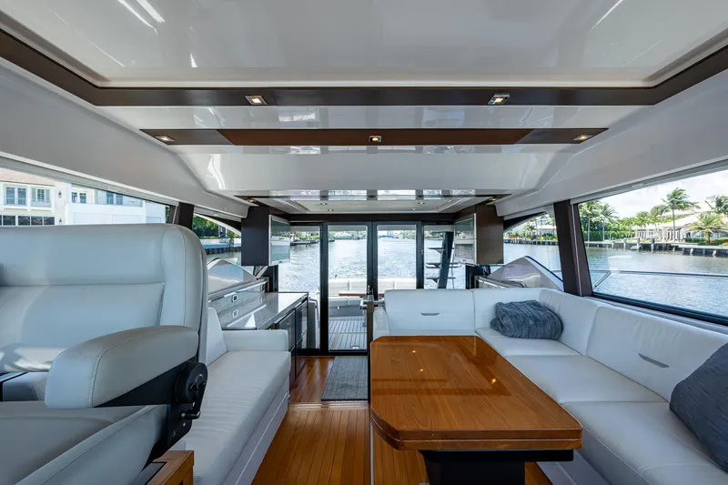 Hwyl Fawr Yacht Photos Pics Luxurious interior of 2018 Tiara Yachts F53 Flybridge with elegant seating and wooden table.