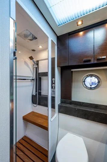Hwyl Fawr Yacht Photos Pics 2018 Tiara Yachts F53 Flybridge bathroom with modern shower and wooden accents.