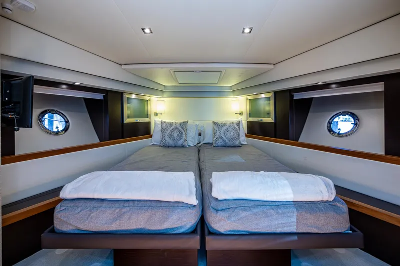 Hwyl Fawr Yacht Photos Pics Luxurious 2018 Tiara Yachts F53 Flybridge cabin with twin beds and elegant decor.