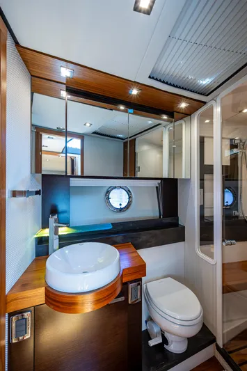 Hwyl Fawr Yacht Photos Pics Luxurious bathroom in 2018 Tiara Yachts F53 Flybridge with modern fixtures and elegant design.