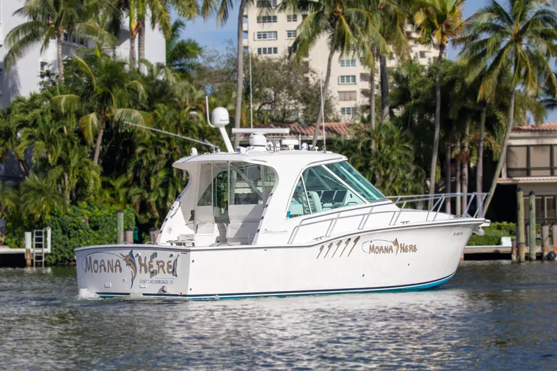 Moana Here Yacht Photos Pics 2015 Albemarle 360 Express Fisherman boat cruising near palm trees and buildings.