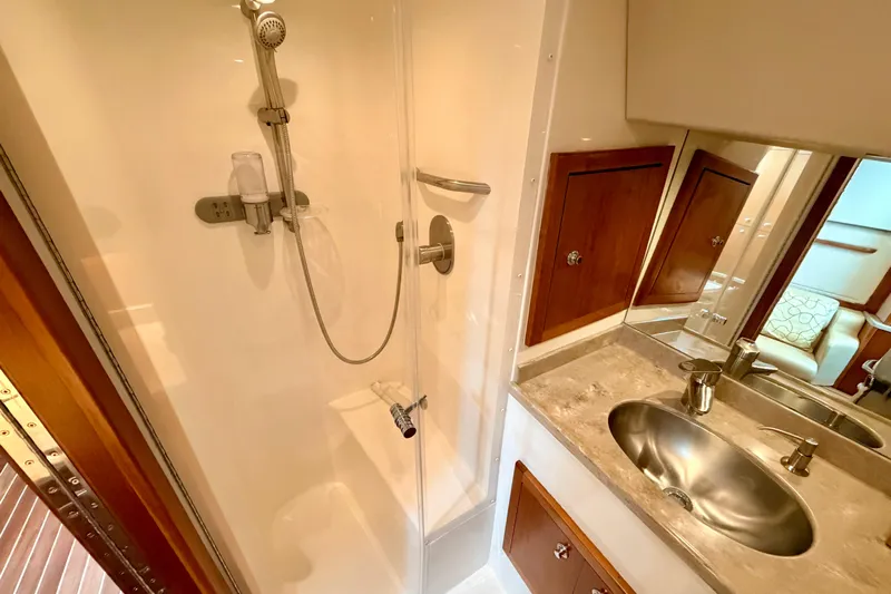 Moana Here Yacht Photos Pics 2015 Albemarle 360 Express Fisherman bathroom with shower, sink, and wooden cabinets.