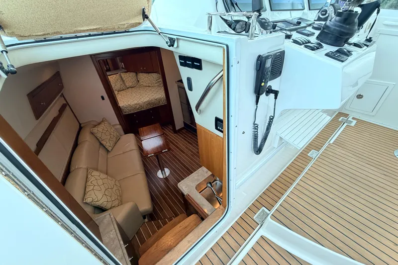 Moana Here Yacht Photos Pics Interior view of 2015 Albemarle 360 Express Fisherman boat, featuring cozy seating and navigation equipment.