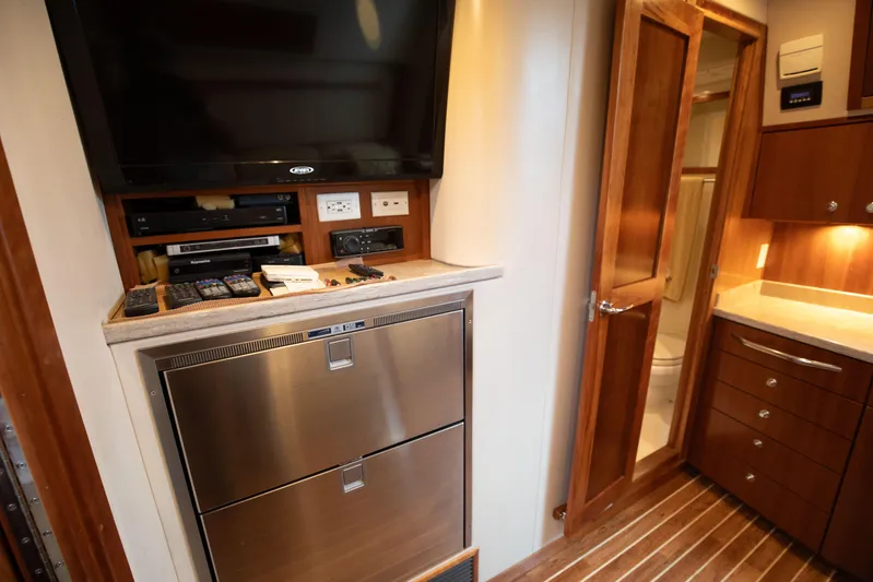 Moana Here Yacht Photos Pics Interior of 2015 Albemarle 360 Express Fisherman with TV, appliances, and wooden cabinetry.