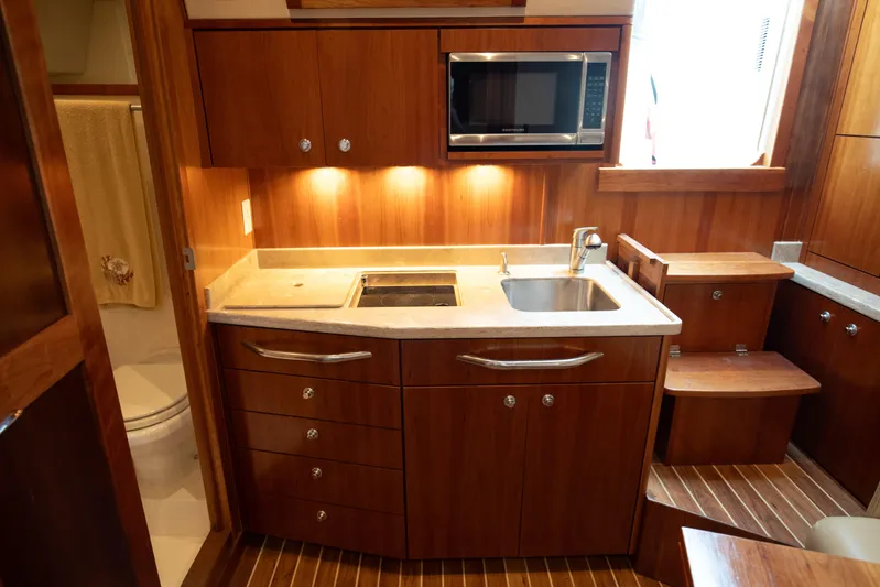 Moana Here Yacht Photos Pics 2015 Albemarle 360 Express Fisherman yacht kitchen with wood cabinetry and modern appliances.