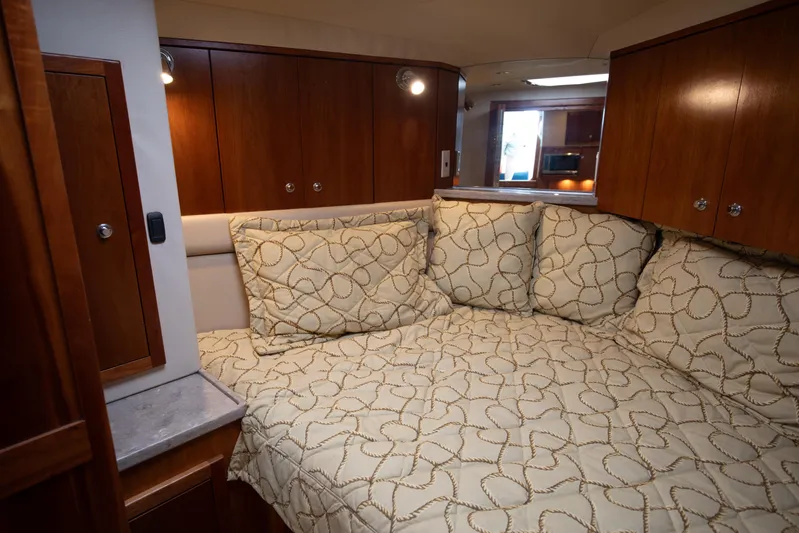 Moana Here Yacht Photos Pics 2015 Albemarle 360 Express Fisherman cabin with cozy bedding and wooden cabinetry.