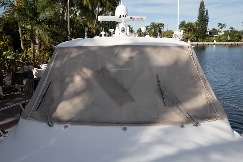 Moana Here Yacht Photos Pics 2015 Albemarle 360 Express Fisherman boat with covered windshield, docked near tropical foliage.