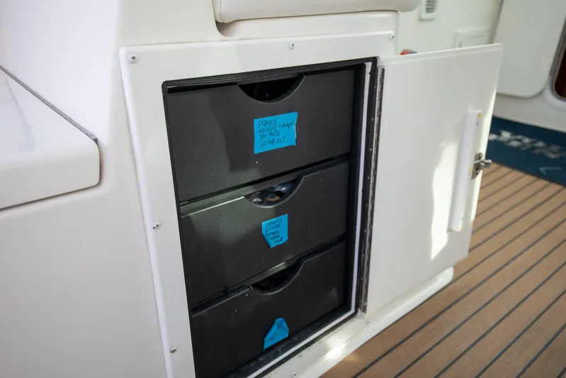 Moana Here Yacht Photos Pics Storage drawers on a 2015 Albemarle 360 Express Fisherman boat, labeled for organization.