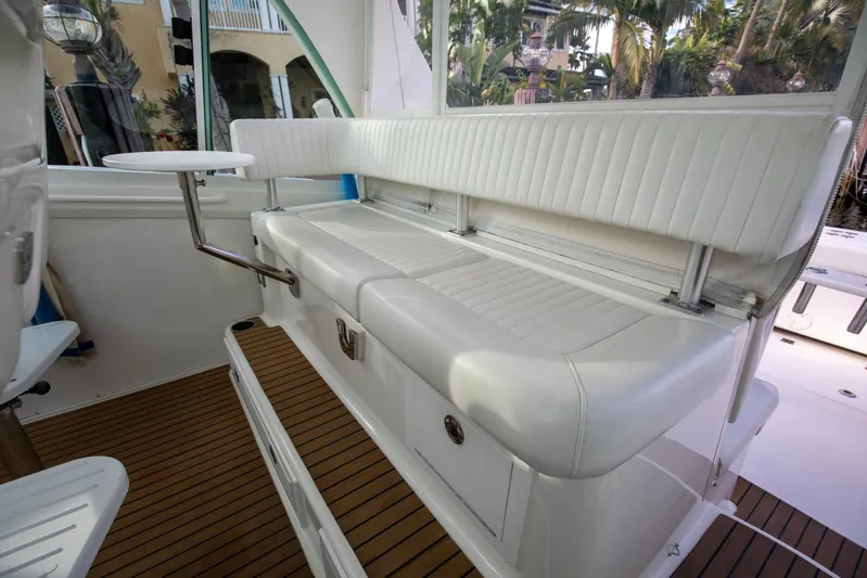 Moana Here Yacht Photos Pics 2015 Albemarle 360 Express Fisherman interior seating with white upholstery and wooden flooring.