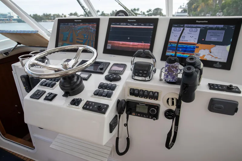 Moana Here Yacht Photos Pics Control panel of 2015 Albemarle 360 Express Fisherman with navigation screens and steering wheel.