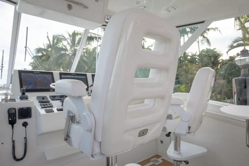 Moana Here Yacht Photos Pics Helm of 2015 Albemarle 360 Express Fisherman with white captain's chairs and control panel.