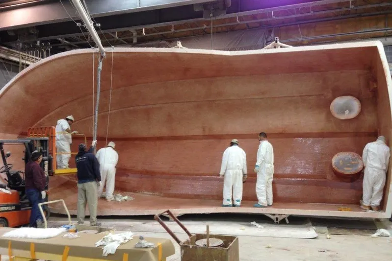 Moana Here Yacht Photos Pics Workers constructing Albemarle 360 Express Fisherman boat hull, 2015 model, in a factory setting.