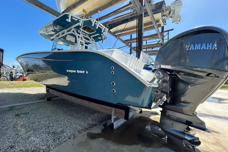  Yacht Photos Pics 2022 Cape Horn 36 boat with Yamaha engine, displayed on a stand outdoors.