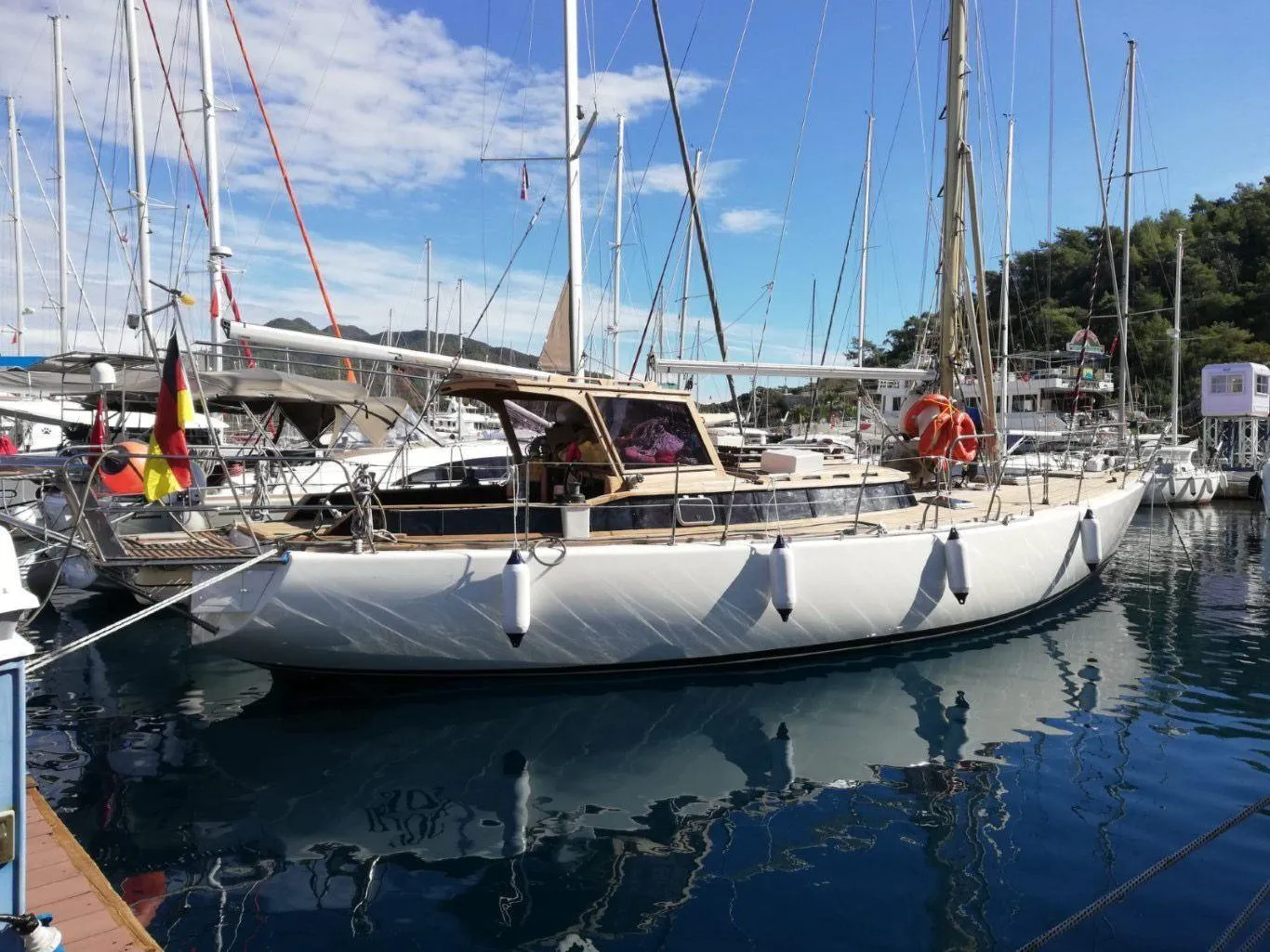 1973 Sloop Beaufort 14 Bluewater Cruiser docked in a marina, surrounded by other boats.