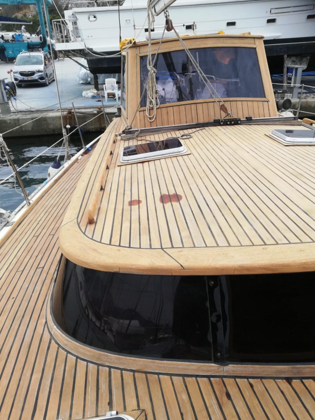 1973 Sloop Beaufort 14 Bluewater Cruiser with wooden deck at marina.