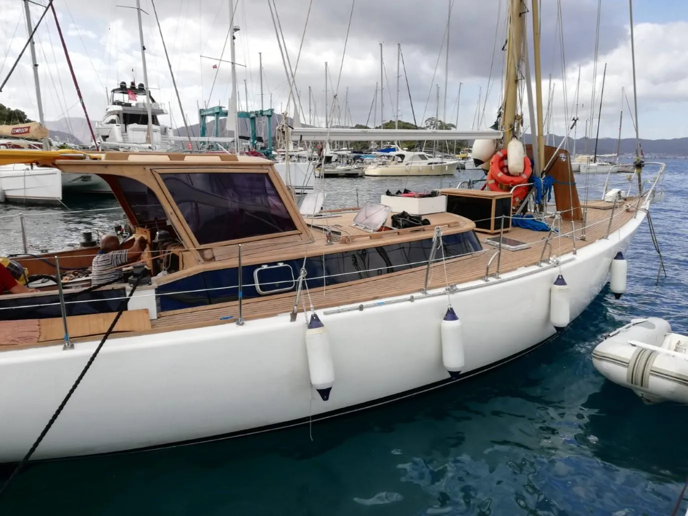 1973 Sloop Beaufort 14 Bluewater Cruiser docked in marina, featuring wooden deck and white hull.