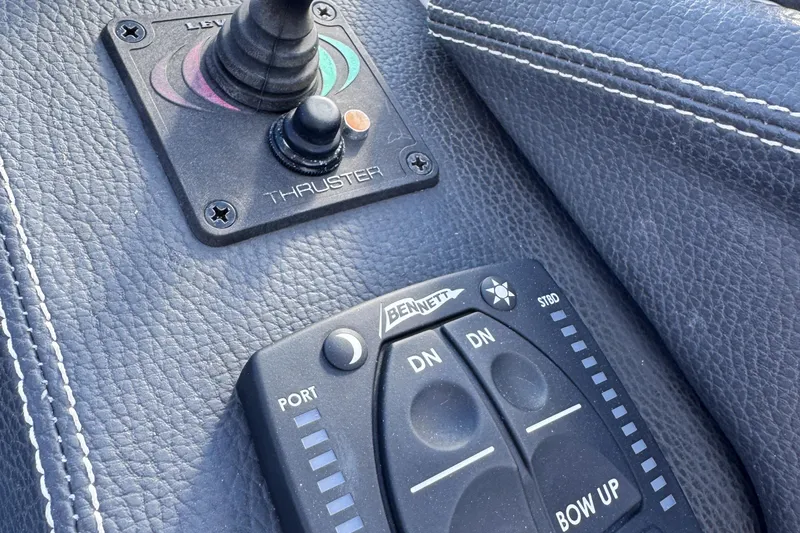  Yacht Photos Pics Close-up of 2018 Regal 29 OBX boat controls, featuring thruster and trim tab buttons.